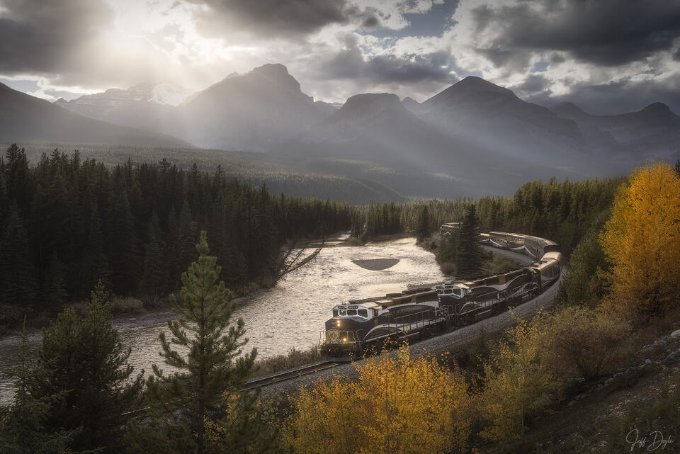 Morant’s Curve in Autumn – Rocky Mountaineer Train Along River Bend with Mountain Backdrop