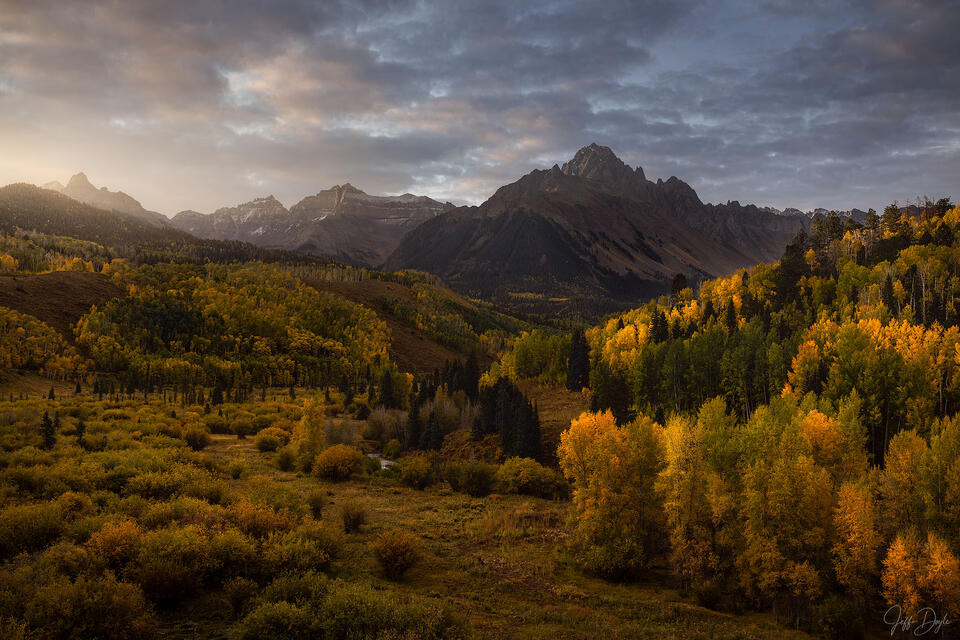 Colorado San Juans – Autumn aspens and golden hills below the jagged peaks at sunrise