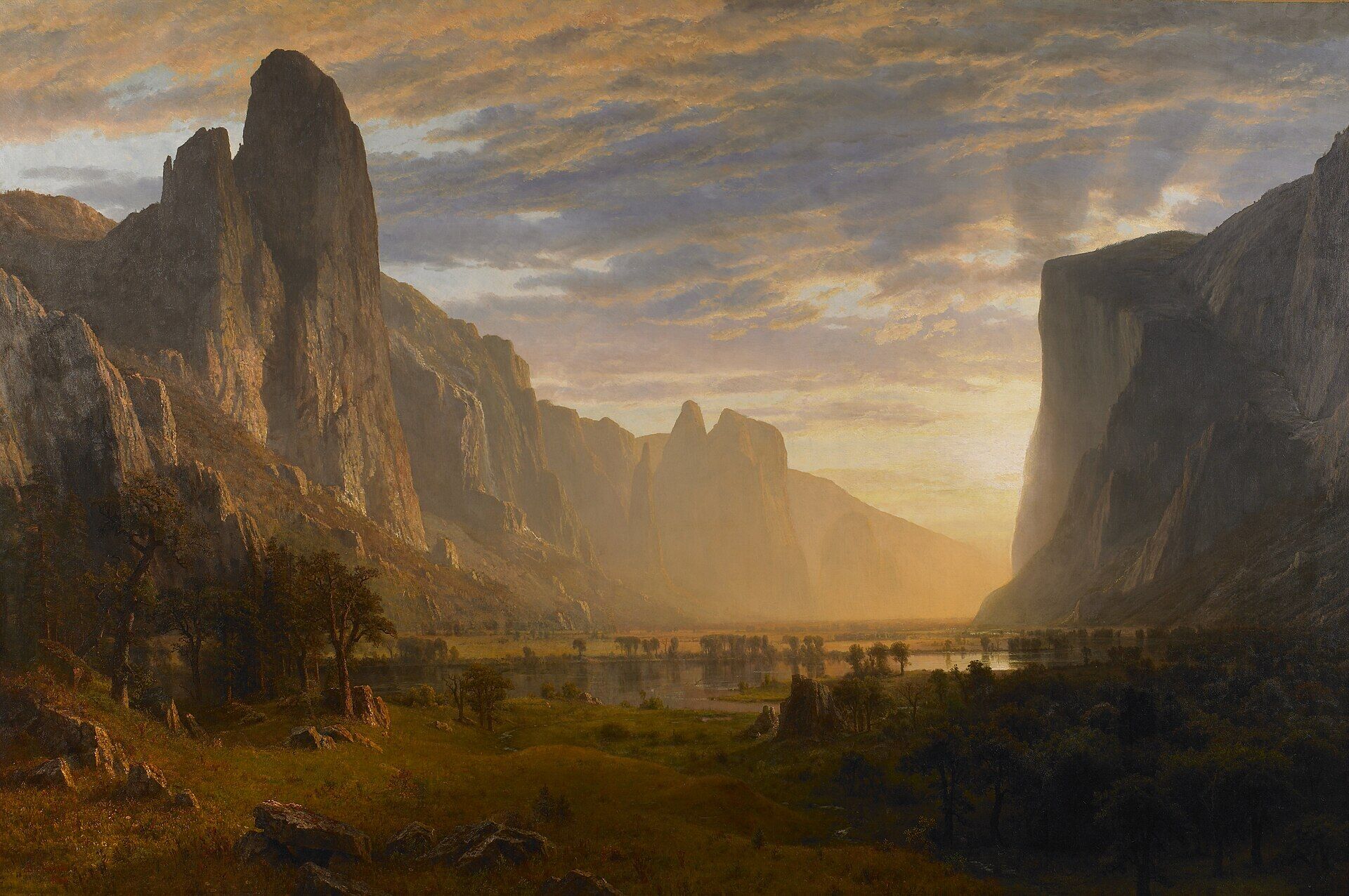 Albert Bierstadt painting of Yosemite Valley at sunset, with towering granite cliffs, glowing clouds, a calm river, distant trees, and warm golden light filling the valley.