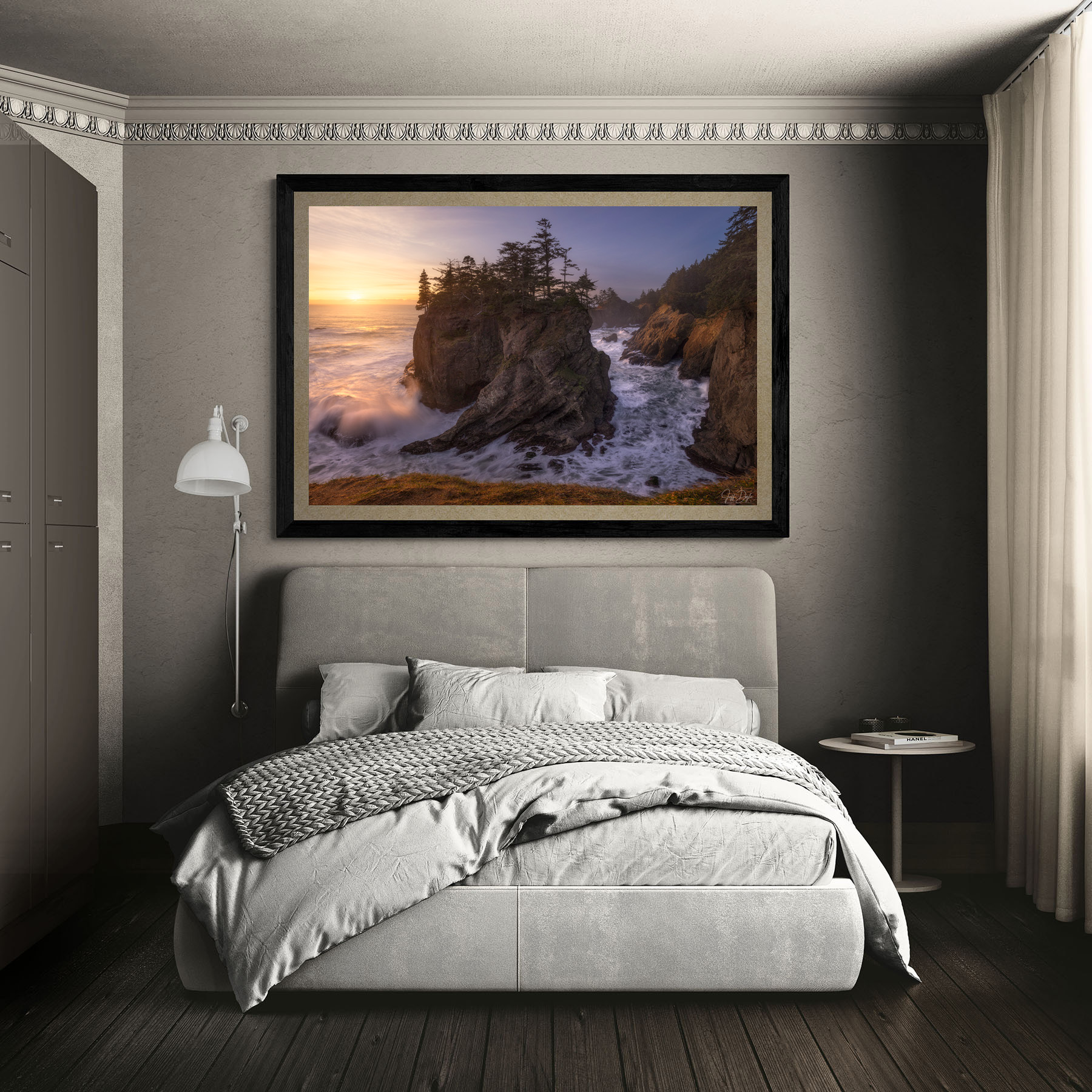 Classic bedroom with modern upholstered bed featuring a large framed fine art coastal landscape print of sea stacks at sunset along the Oregon Coast displayed above the headboard.