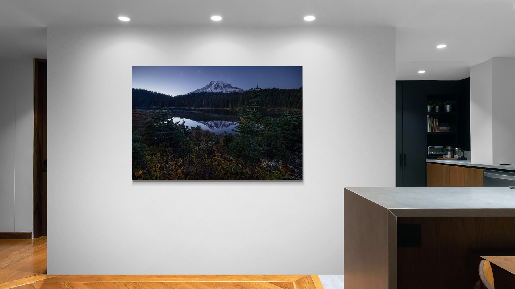 Fine art photograph of an alpine lake reflection displayed in a modern kitchen – showing how landscape photography transforms a room with natural and evening light