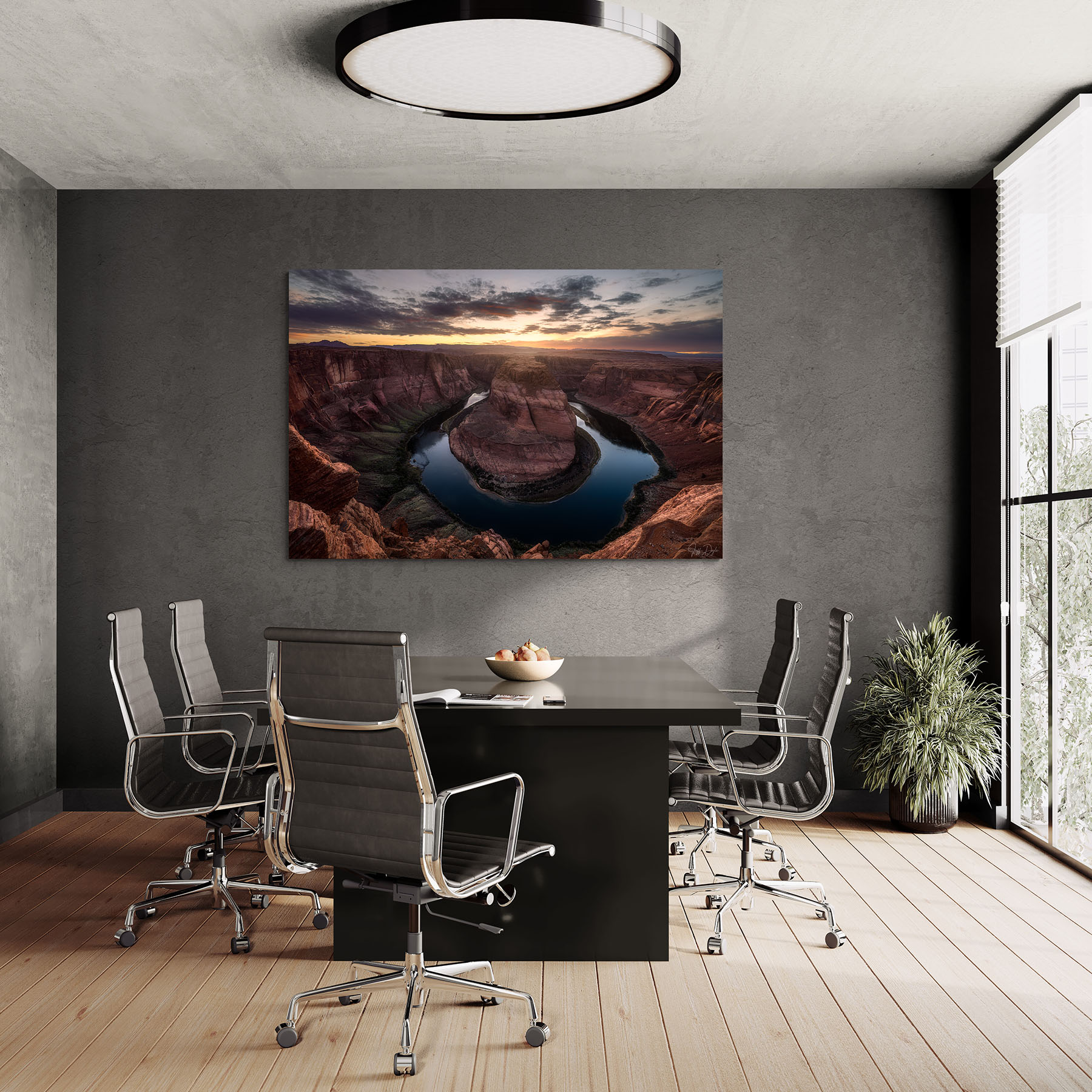 Modern executive meeting room with large windows featuring a fine art landscape print of Horseshoe Bend along the Colorado River in Page, Arizona displayed above a conference table.